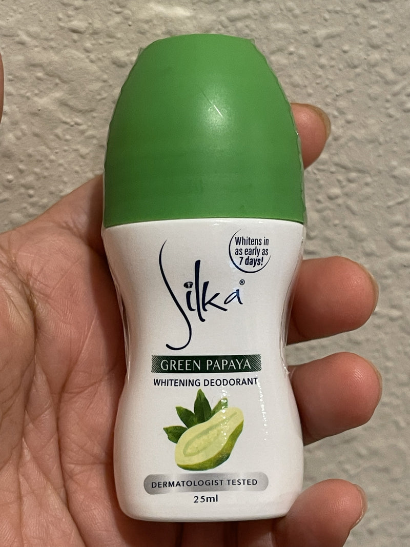 Silka Green Papaya Whitening Deodorant held in a hand against a neutral background